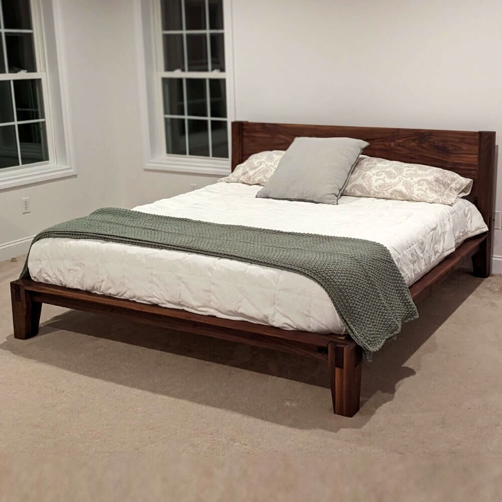 Handmade solid walnut bed frame with castle joints by Canterbury Woods Creations