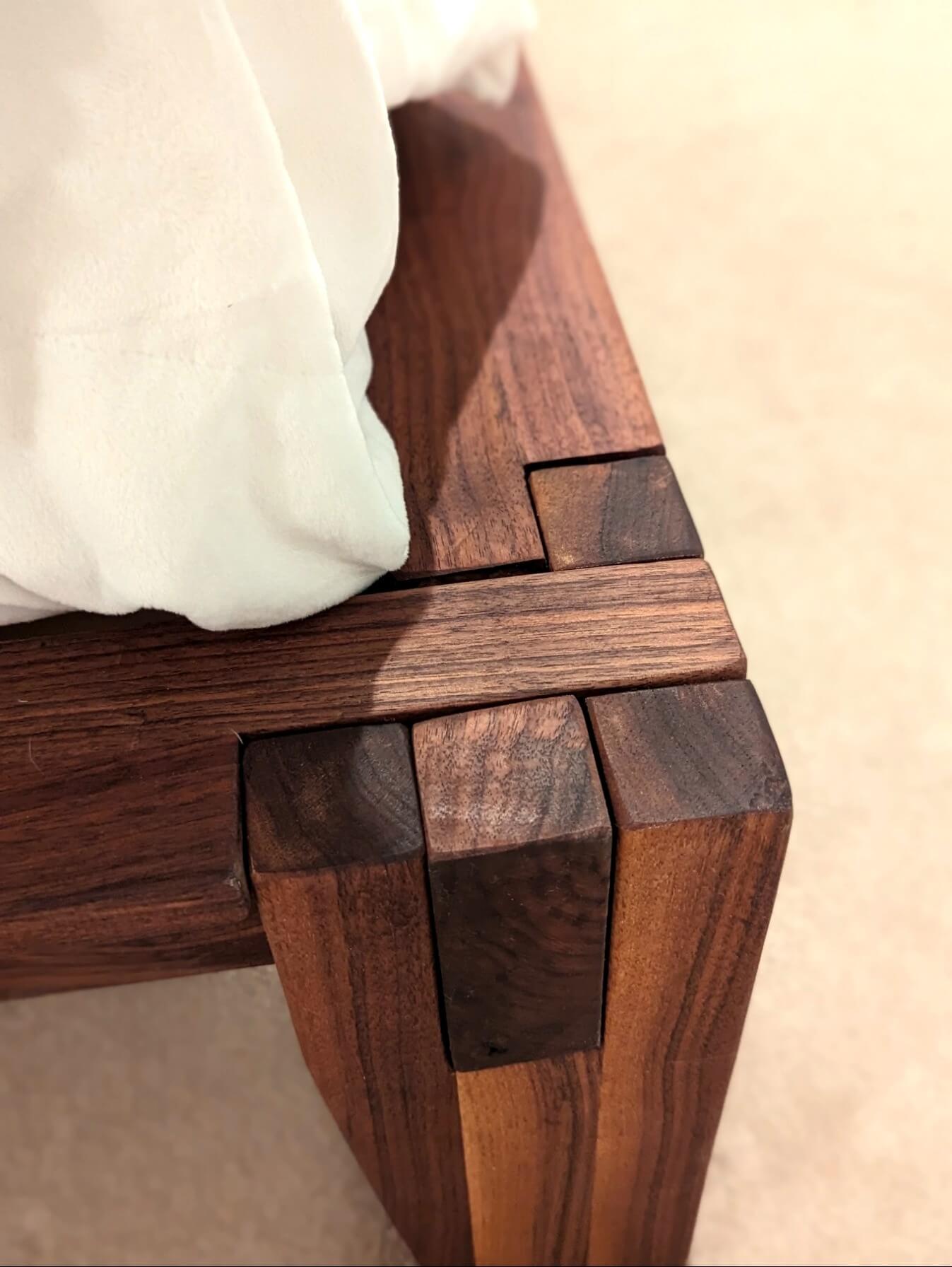Hand-cut castle joint at the corner of The Bastion walnut bed